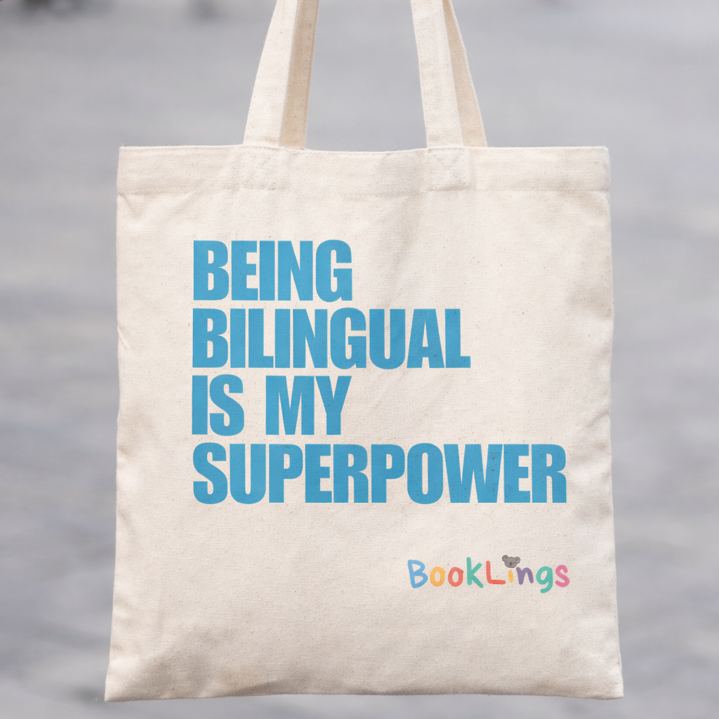 Tote bag with 'Being Bilingual is My Superpower' text held by a person outdoors.